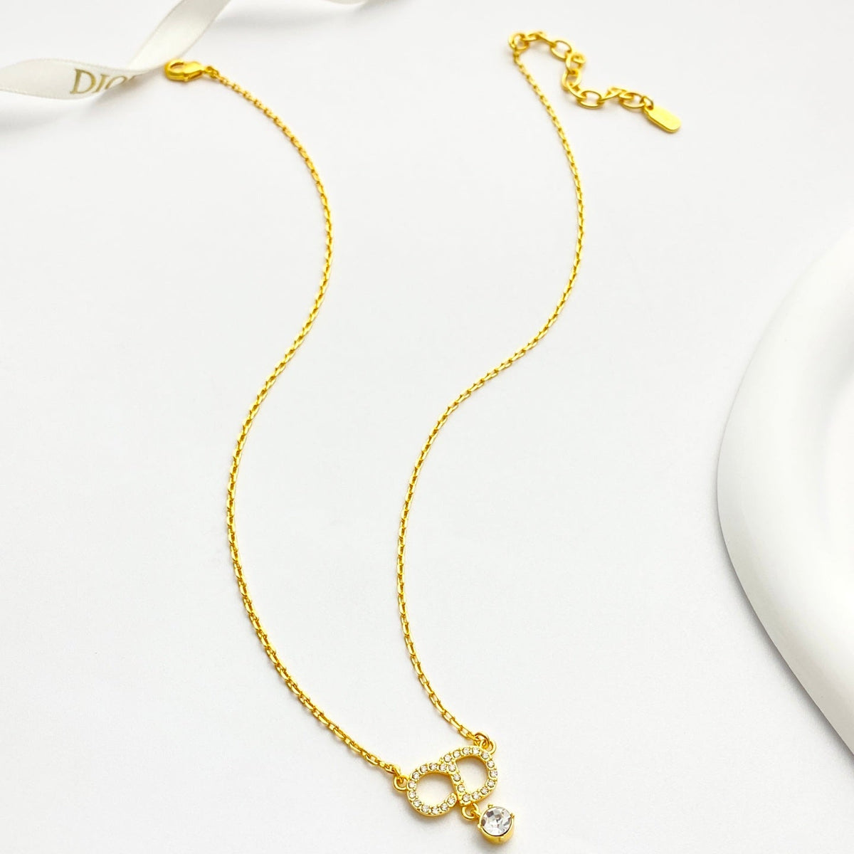 Martin Graham pendant necklace in polished metal-tone – close-up detail