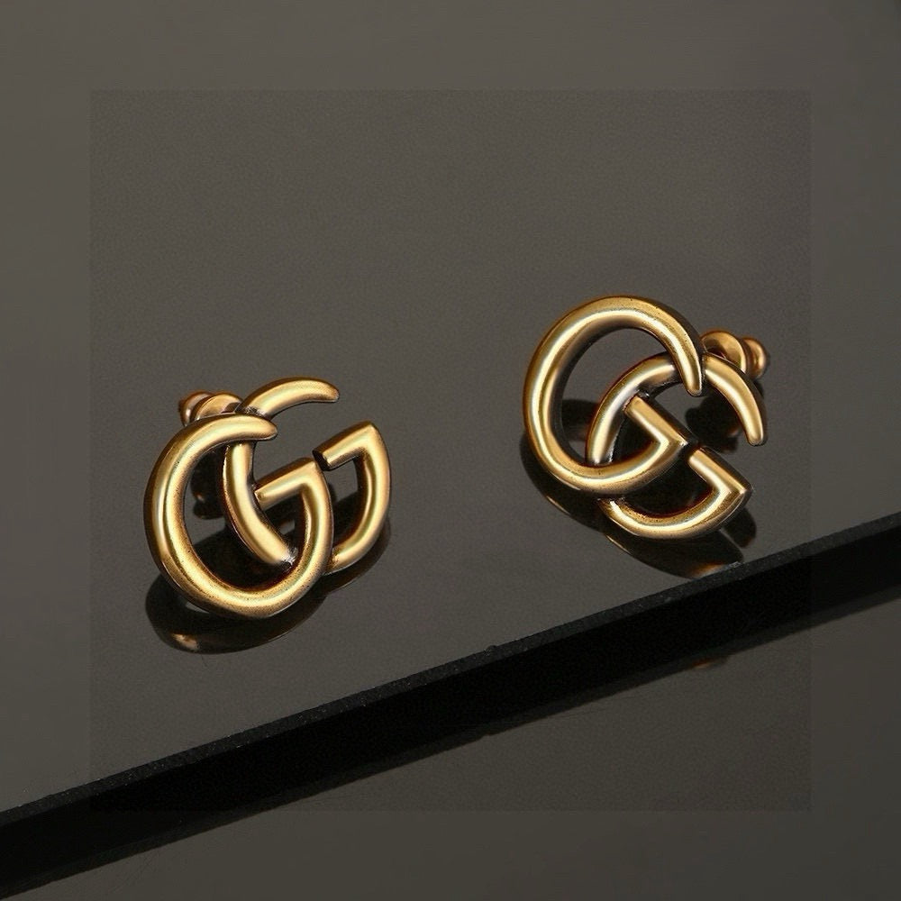 Martin Graham stud earrings in polished metal-tone – detail view