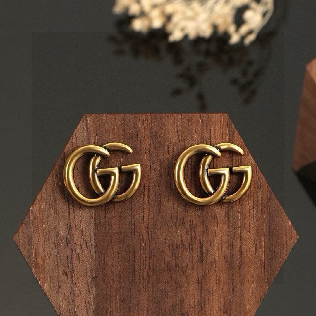 Martin Graham stud earrings in polished metal-tone – front product view