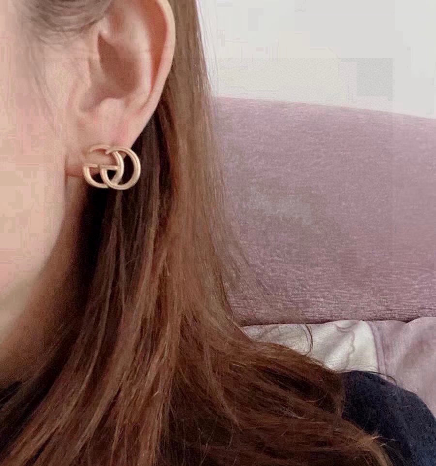 Martin Graham stud earrings in polished metal-tone – close-up detail