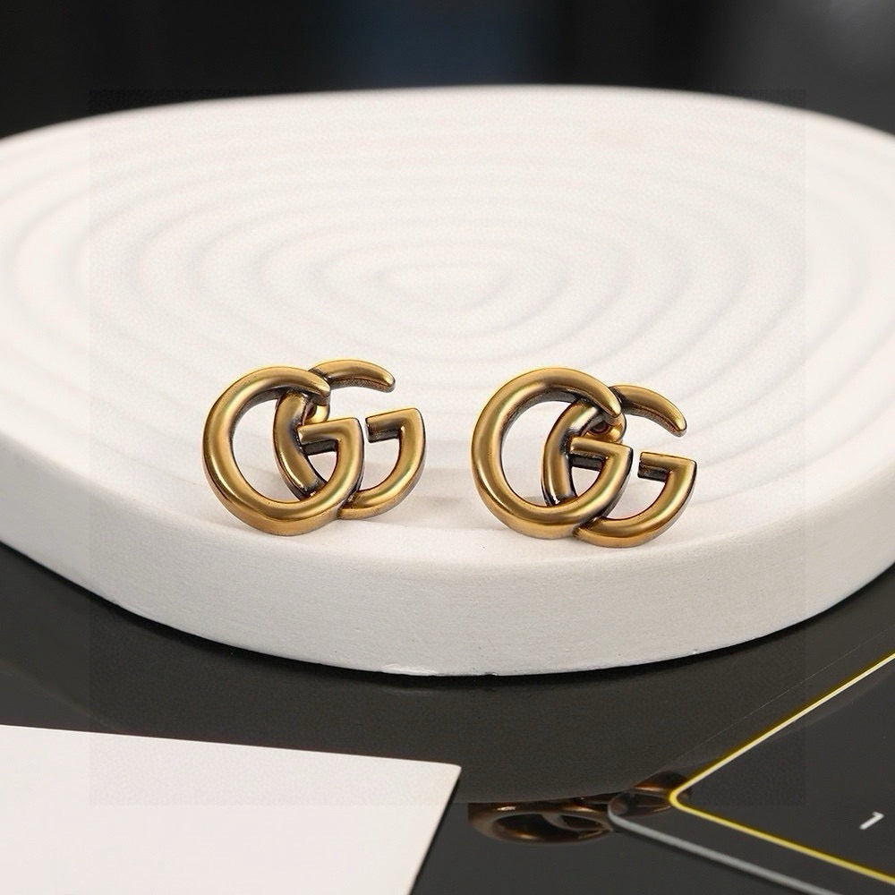 Martin Graham stud earrings in polished metal-tone – side detail