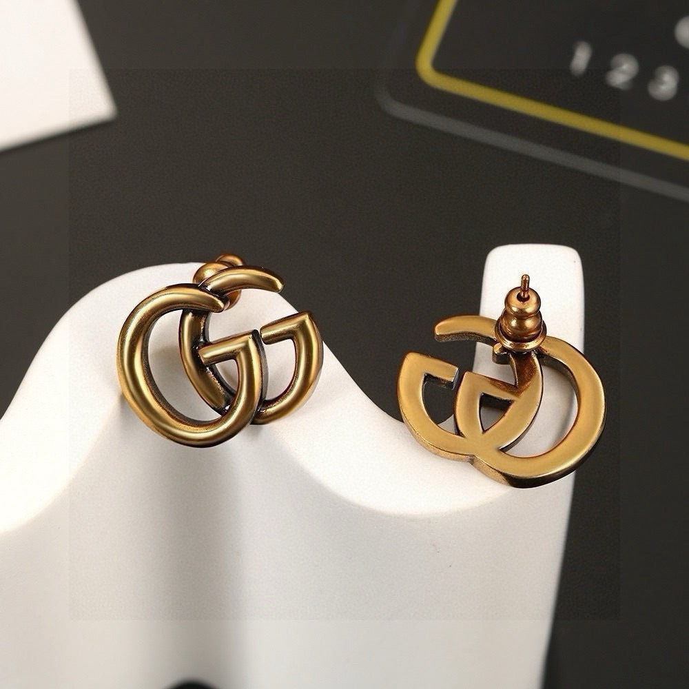 Martin Graham stud earrings in polished metal-tone – styled product view