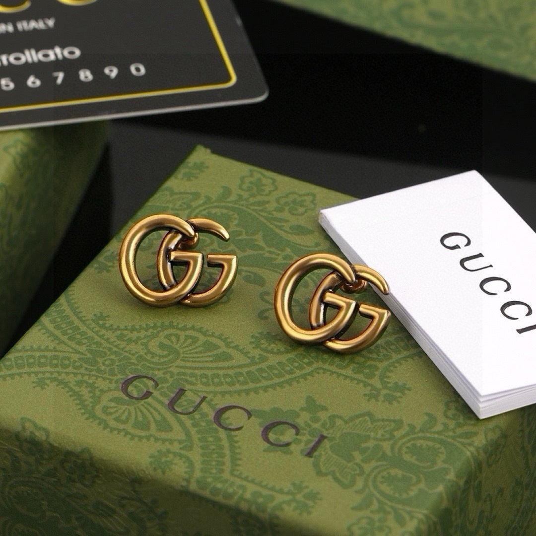 Martin Graham stud earrings in polished metal-tone – front product view
