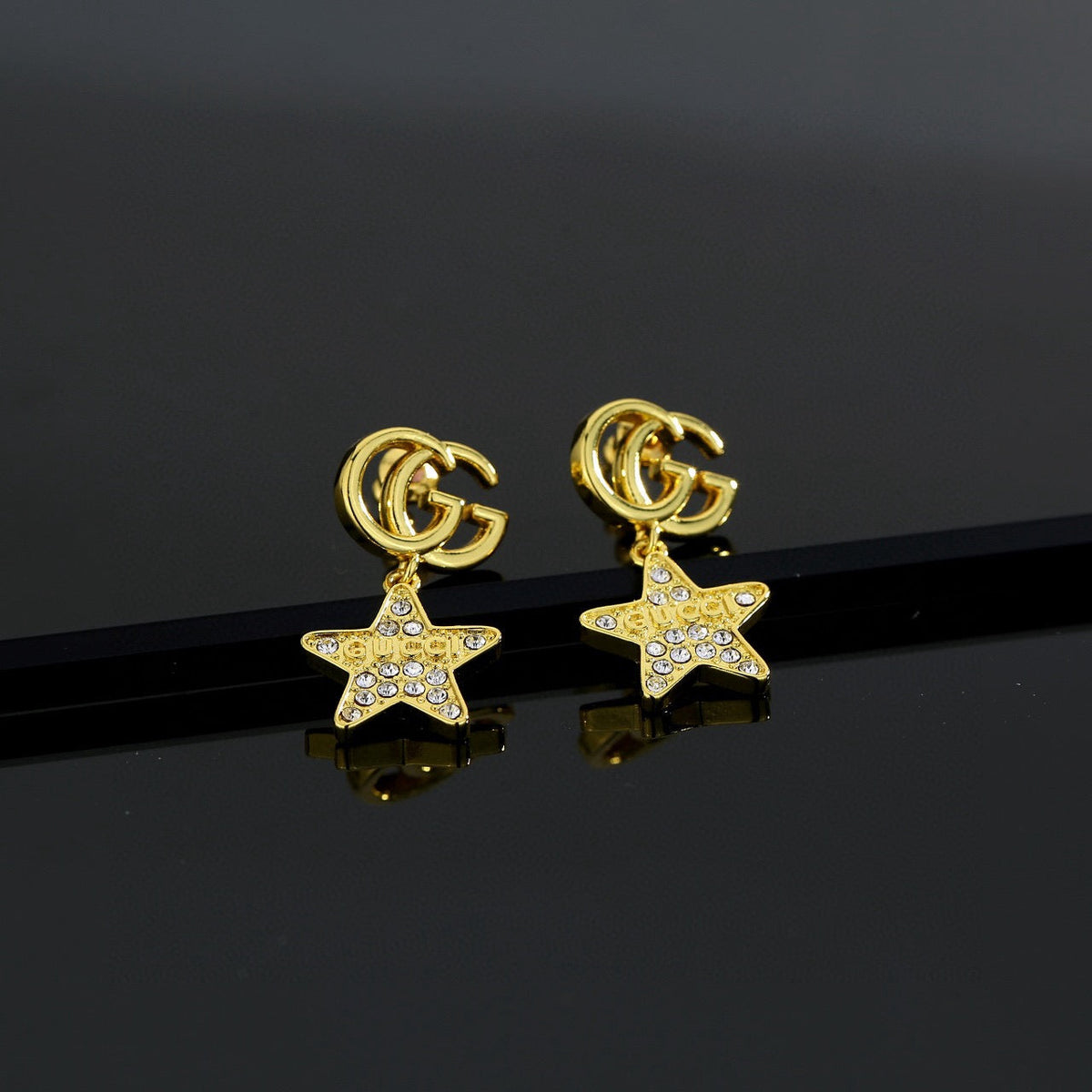 Martin Graham stud earrings in polished metal-tone – front product view
