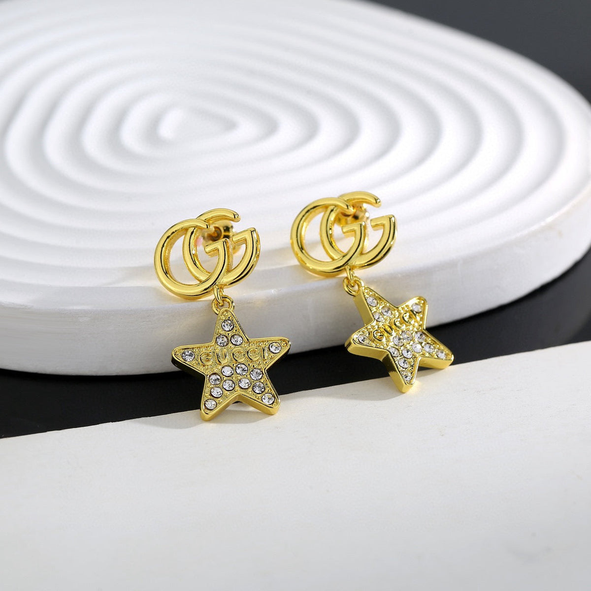 Martin Graham stud earrings in polished metal-tone – styled product view