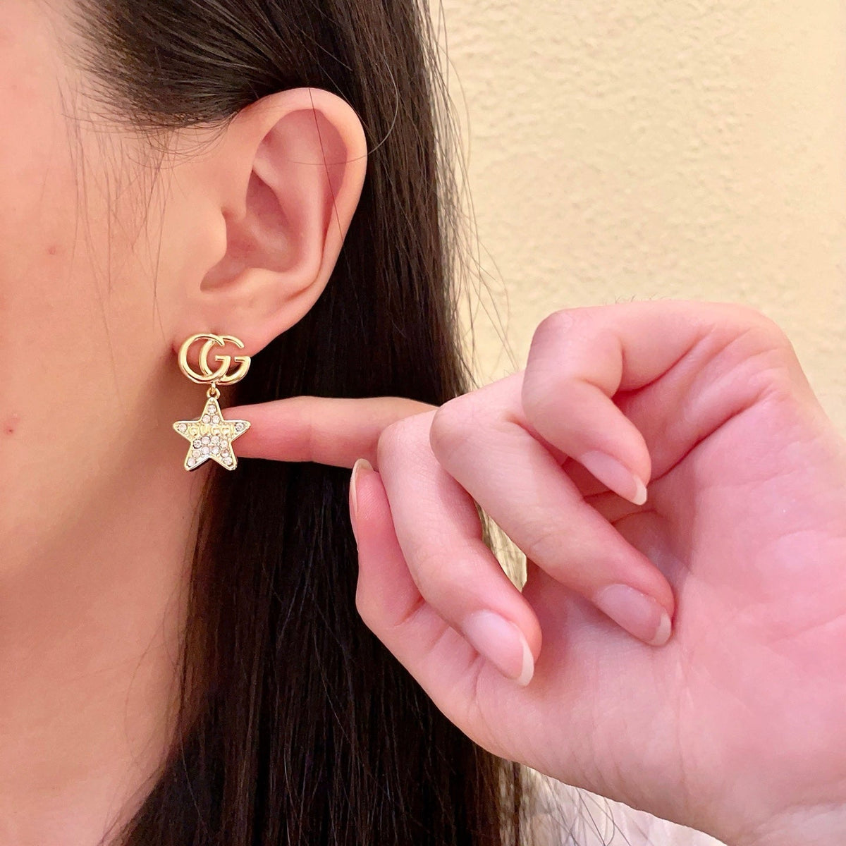 Martin Graham stud earrings in polished metal-tone – close-up detail