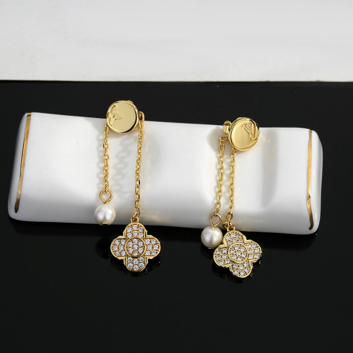 Martin Graham stud earrings in polished metal-tone – close-up detail