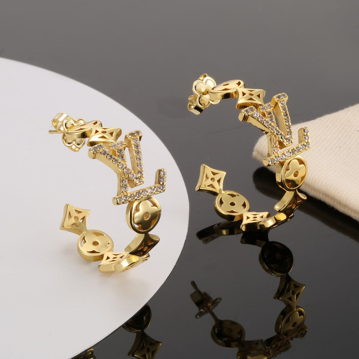 Martin Graham stud earrings in polished metal-tone – detail view