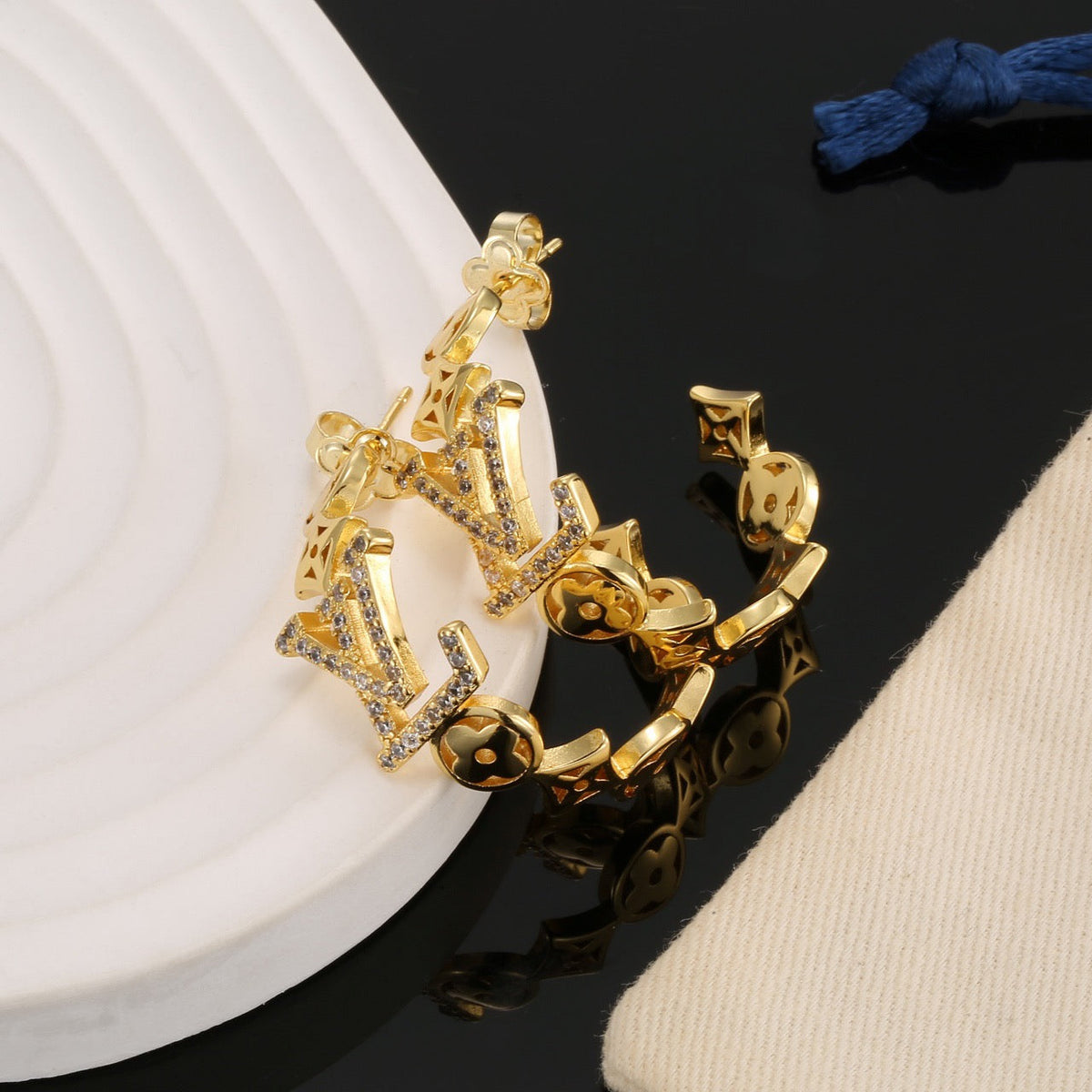 Martin Graham stud earrings in polished metal-tone – close-up detail