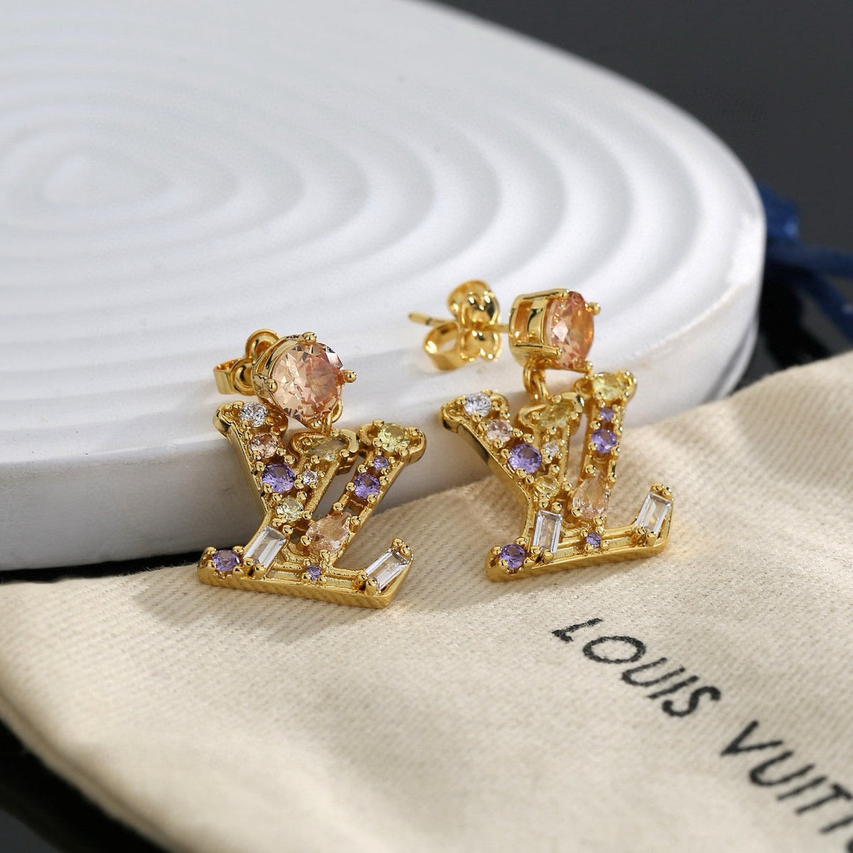 Martin Graham stud earrings in polished metal-tone – close-up detail
