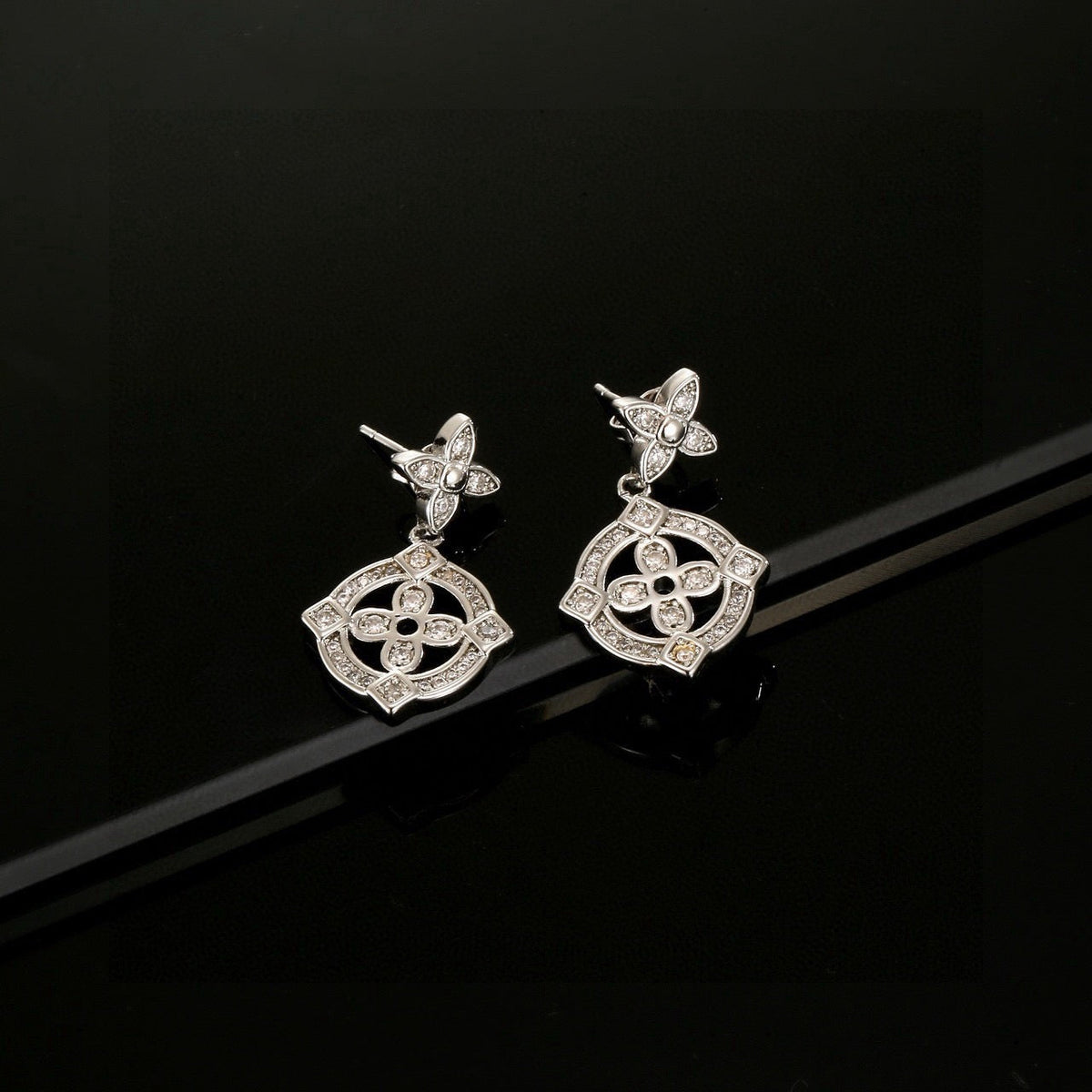 Martin Graham stud earrings in polished metal-tone – side detail