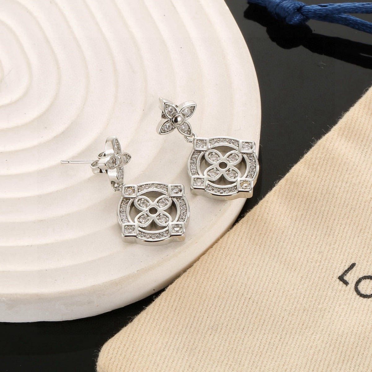 Martin Graham stud earrings in polished metal-tone – close-up detail