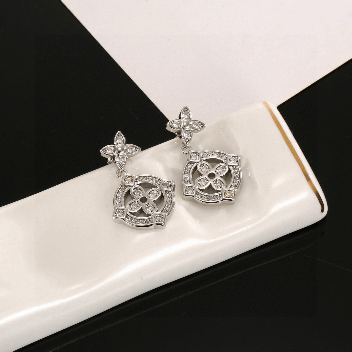 Martin Graham stud earrings in polished metal-tone – styled product view