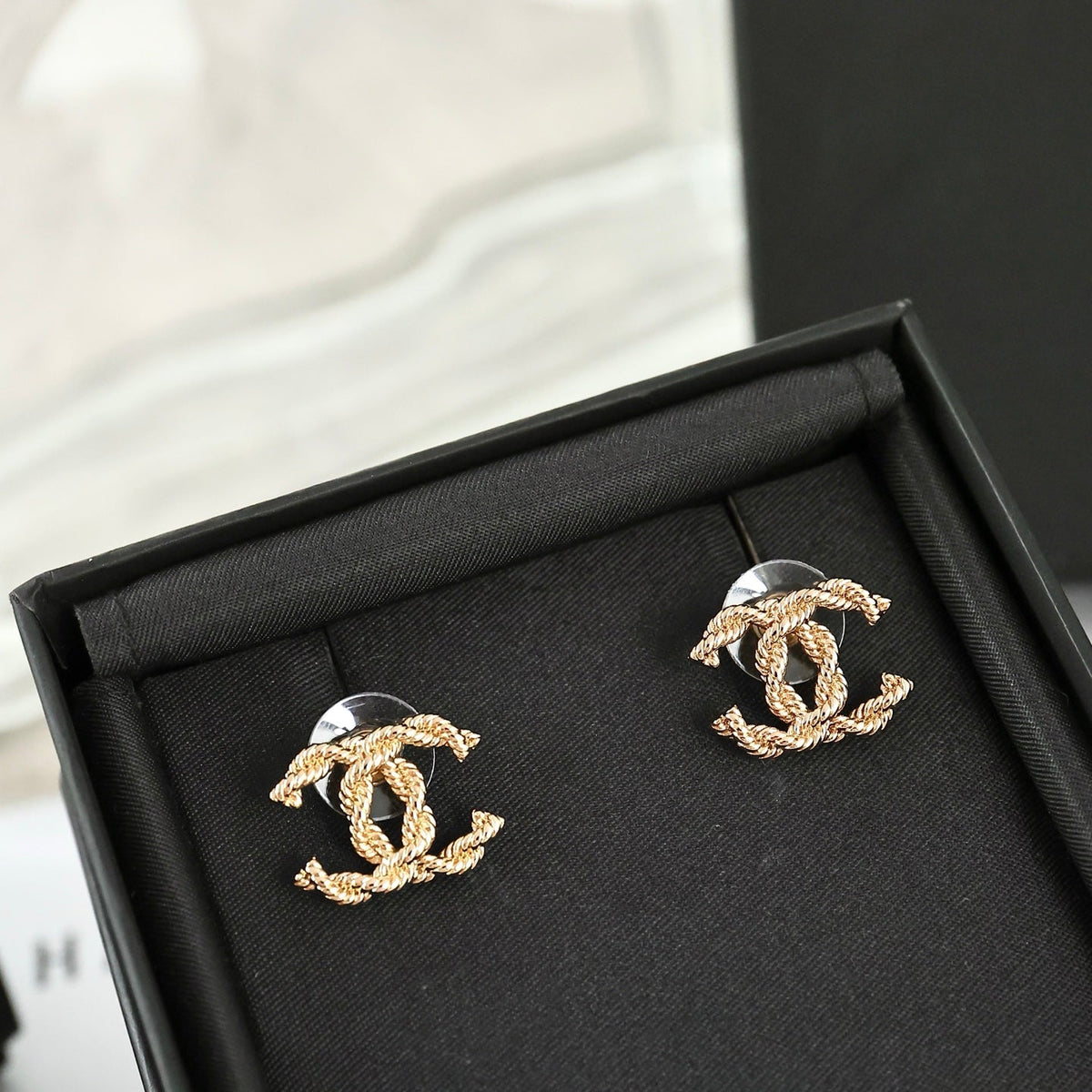 Martin Graham stud earrings in polished metal-tone – close-up detail