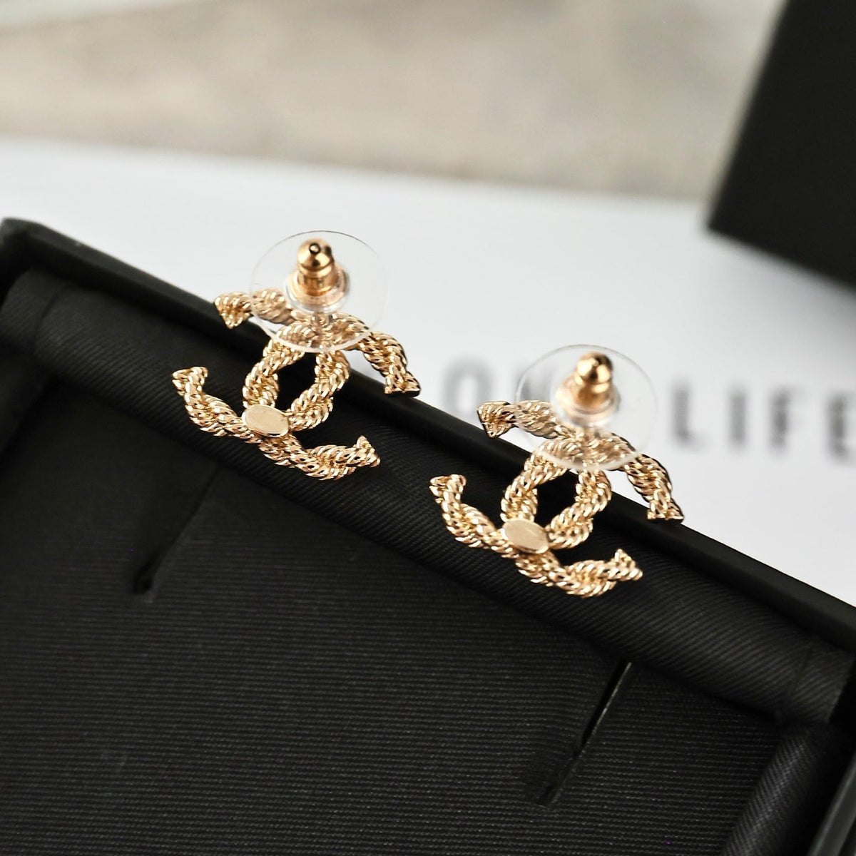 Martin Graham stud earrings in polished metal-tone – side detail