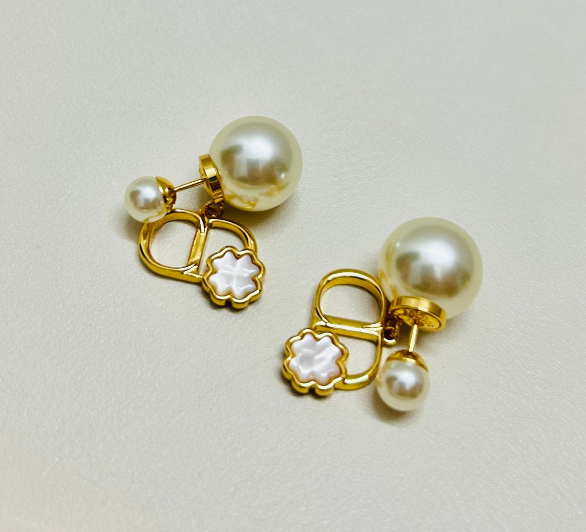 Martin Graham stud earrings in polished metal-tone – close-up detail