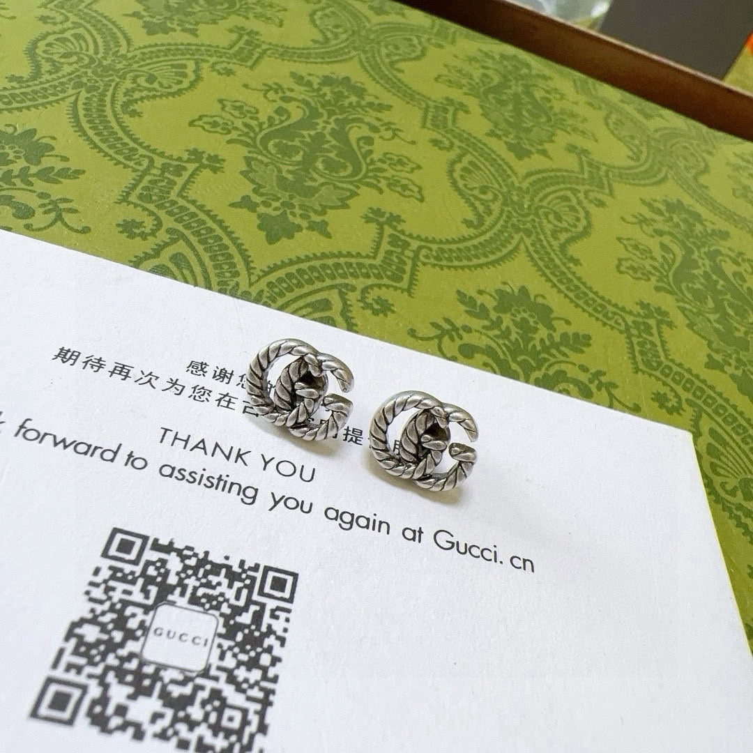 Martin Graham stud earrings in polished metal-tone – styled product view