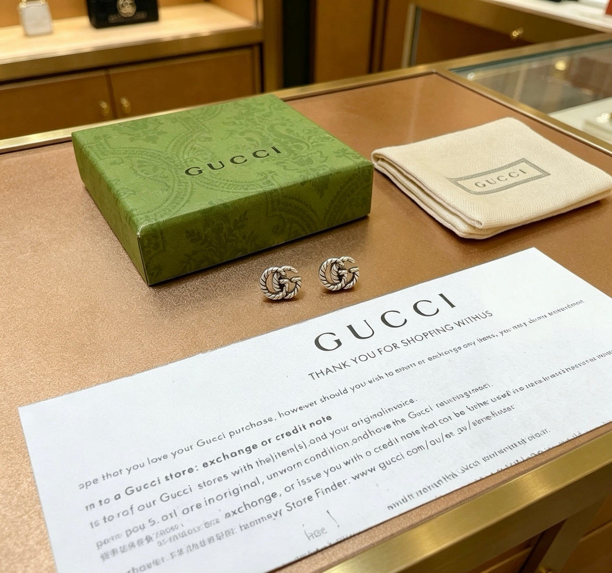 Martin Graham stud earrings in polished metal-tone – side detail