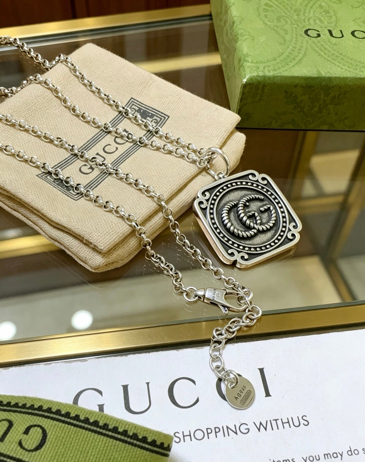 Martin Graham pendant necklace in polished metal-tone – close-up detail