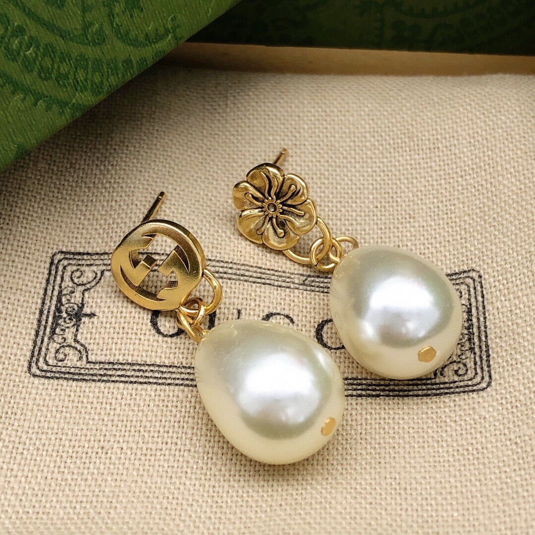 Martin Graham earrings in polished metal-tone – close-up detail