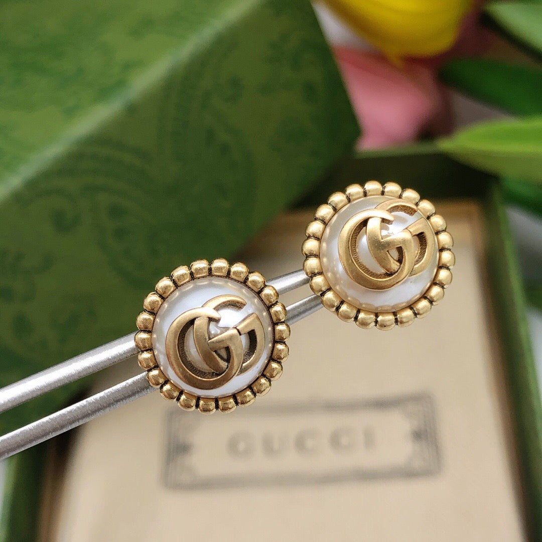 Martin Graham stud earrings in polished metal-tone – styled product view