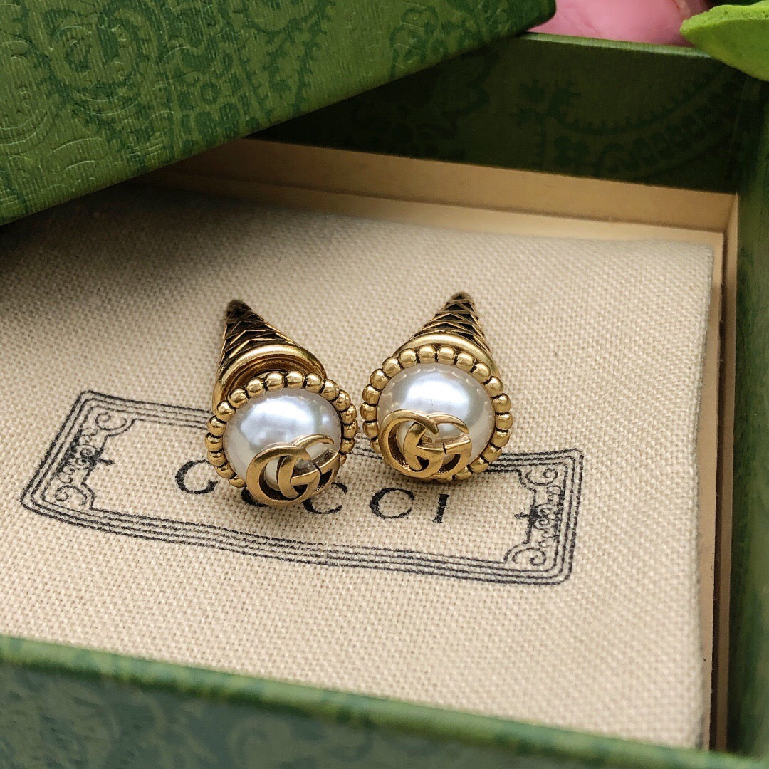 Martin Graham stud earrings in polished metal-tone – close-up detail
