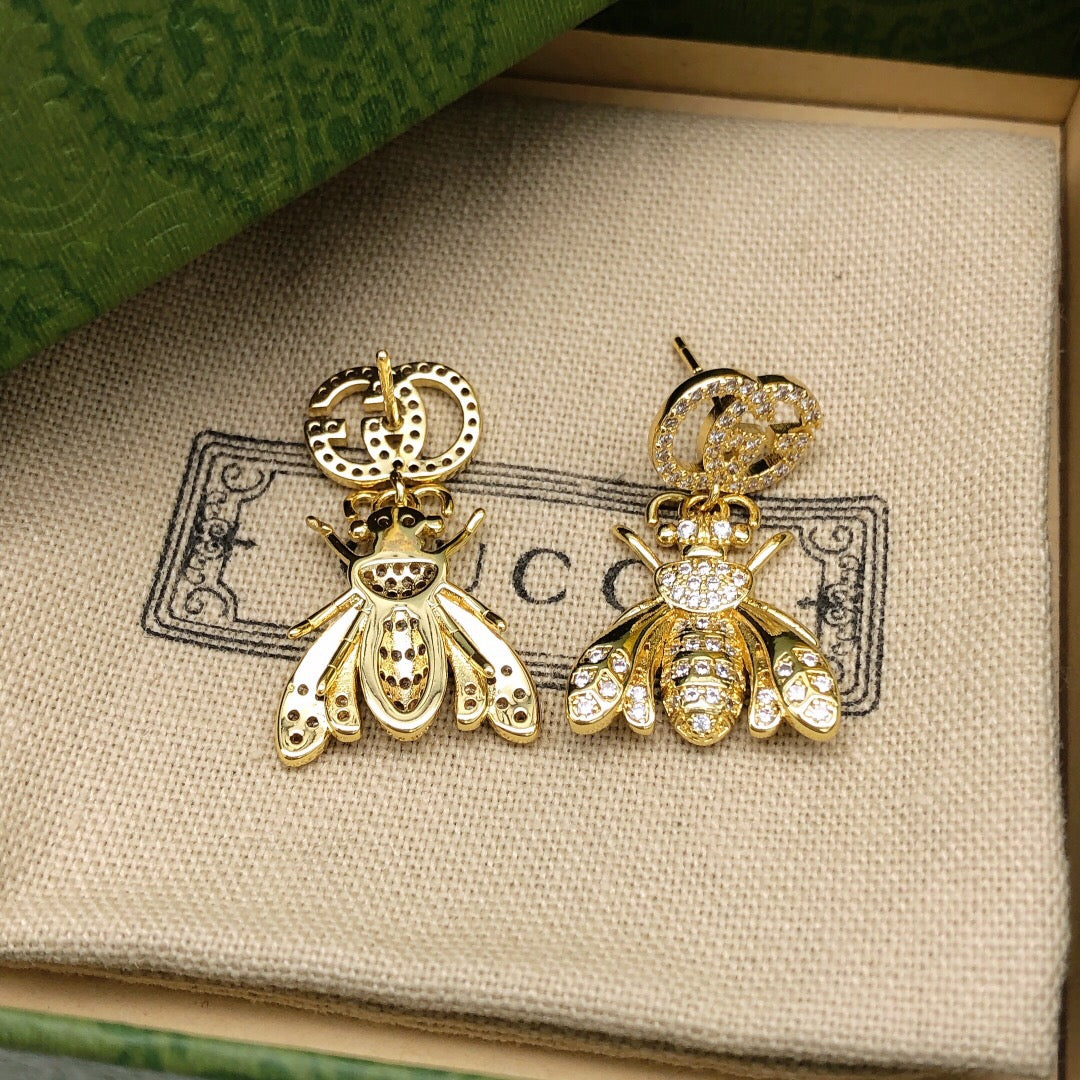 Martin Graham earrings in polished metal-tone – close-up detail