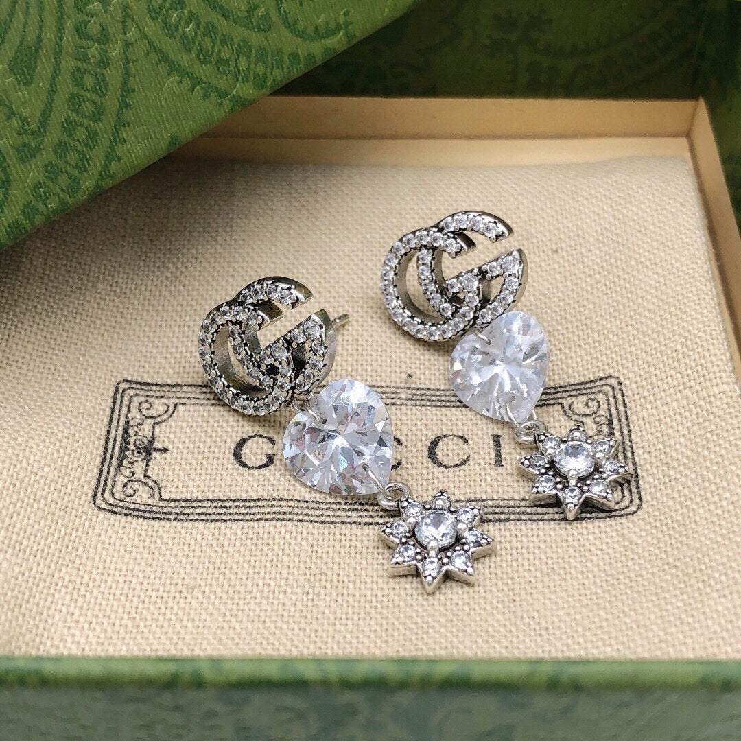 Martin Graham stud earrings in polished metal-tone – close-up detail
