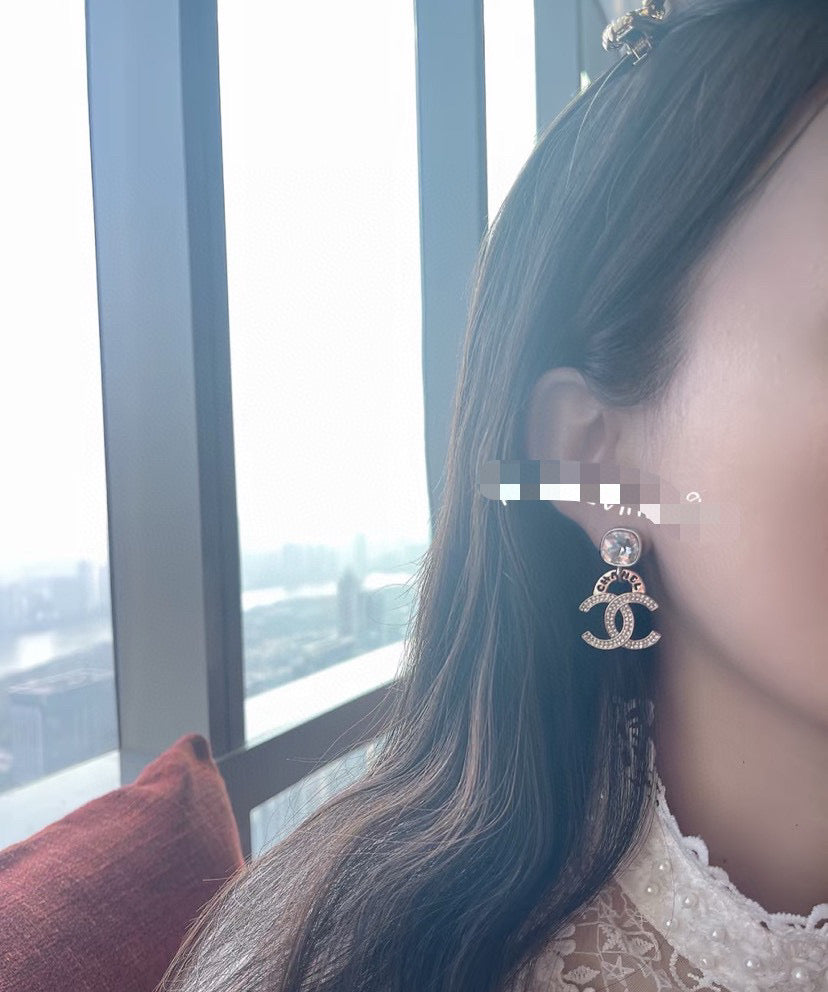 Martin Graham stud earrings in polished metal-tone – close-up detail