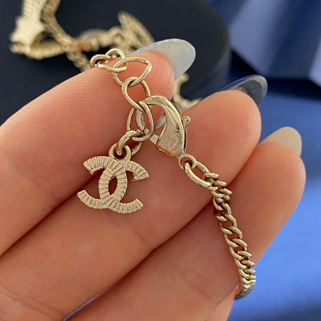 Martin Graham pendant necklace in polished metal-tone – close-up detail