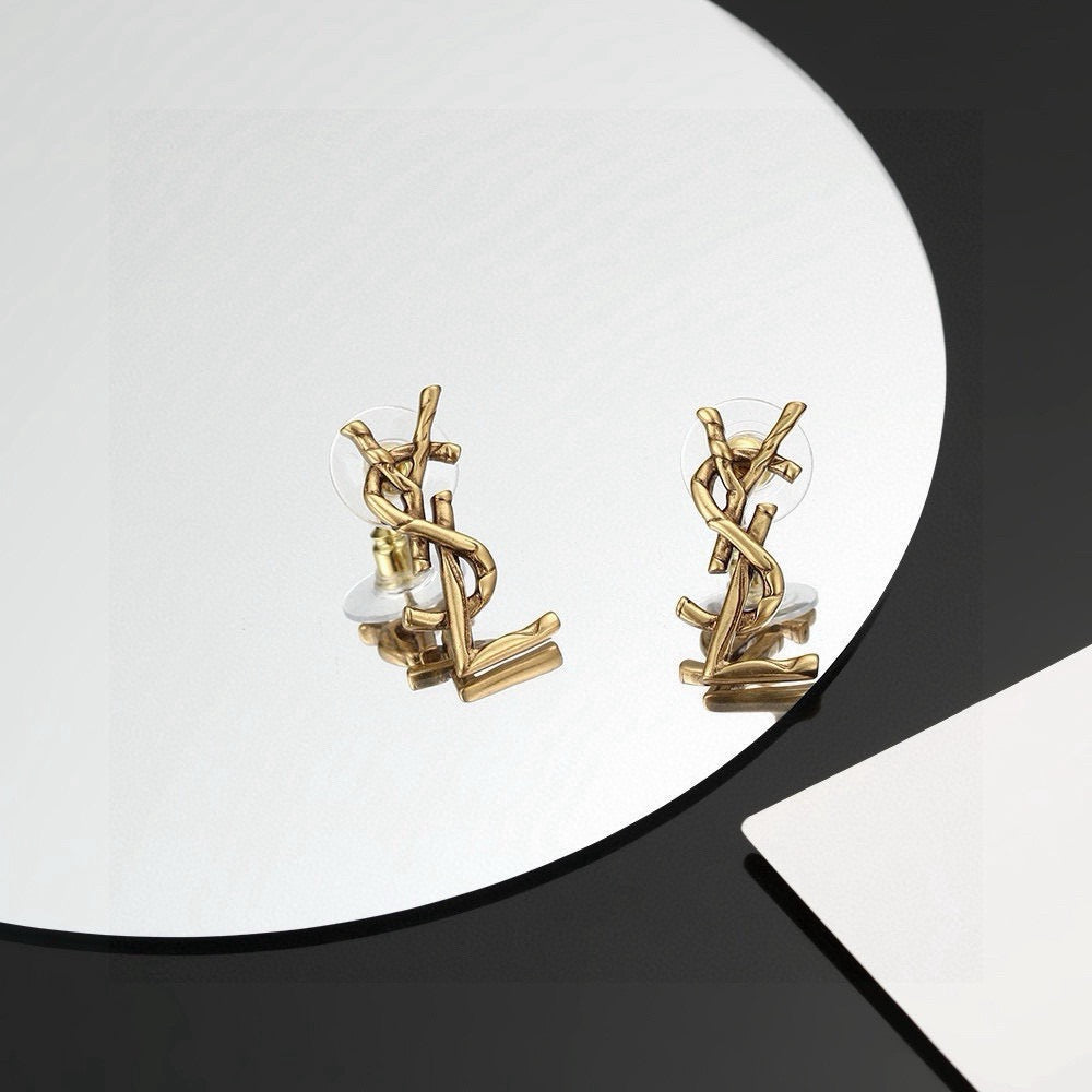 Martin Graham stud earrings in polished metal-tone – styled product view