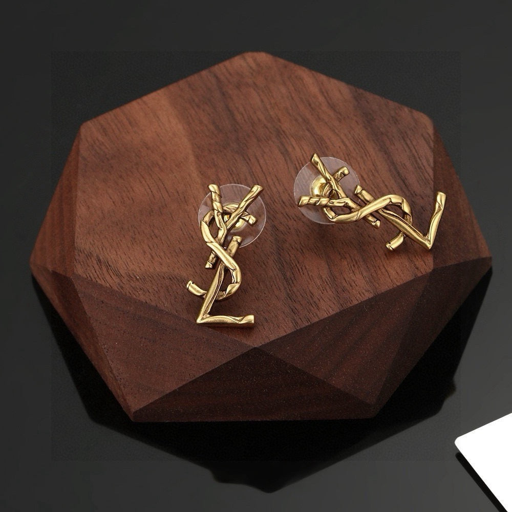 Martin Graham stud earrings in polished metal-tone – close-up detail