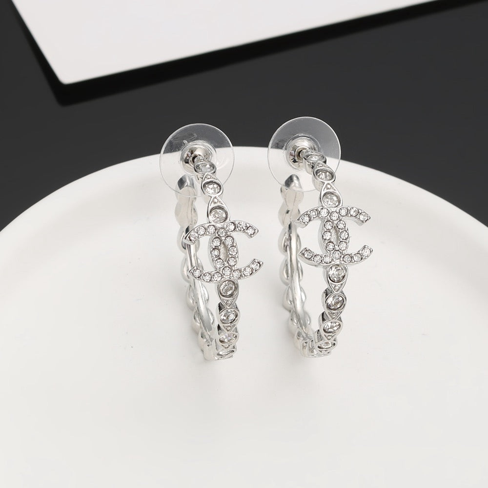 Martin Graham stud earrings in polished metal-tone – close-up detail