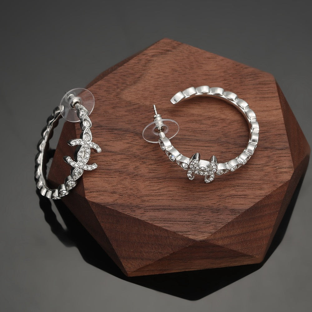 Martin Graham stud earrings in polished metal-tone – styled product view