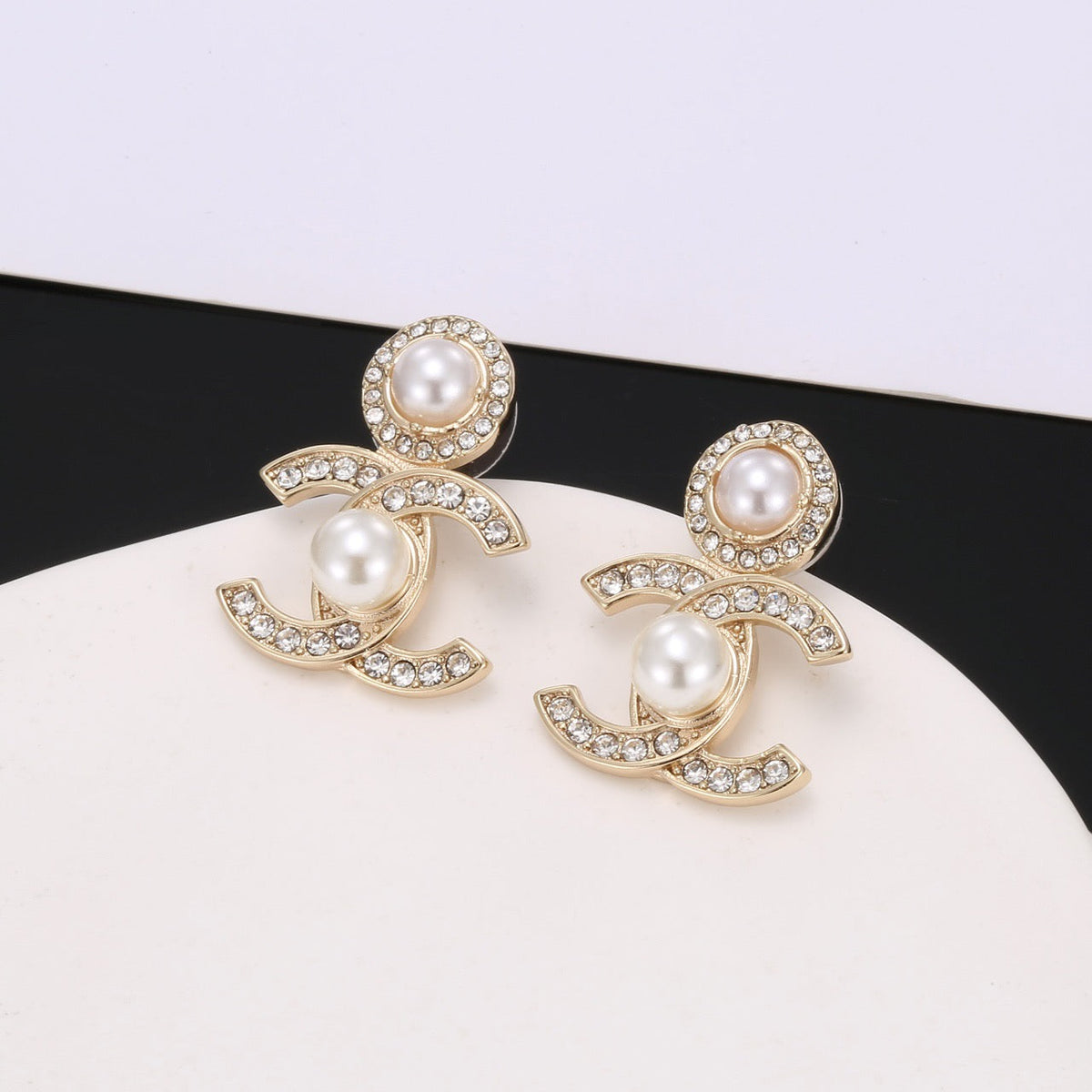 Martin Graham stud earrings in polished metal-tone – side detail