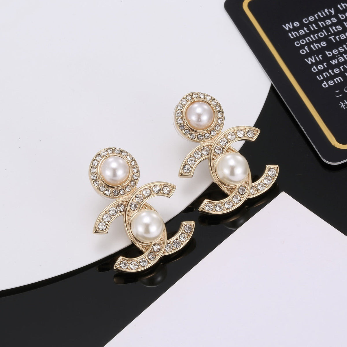 Martin Graham stud earrings in polished metal-tone – close-up detail