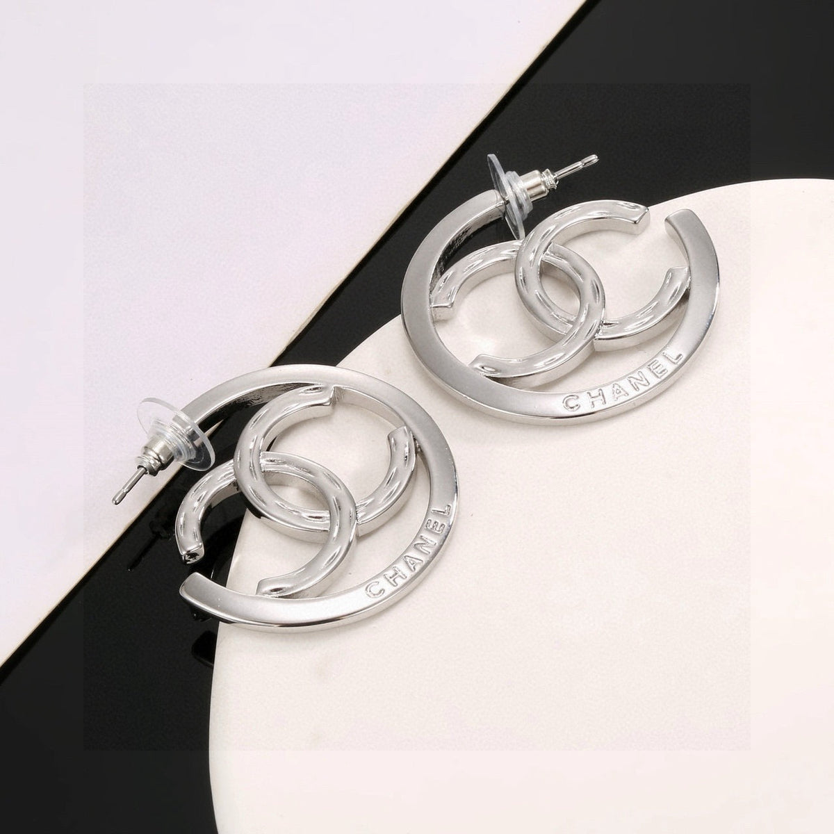 Martin Graham stud earrings in polished metal-tone – detail view