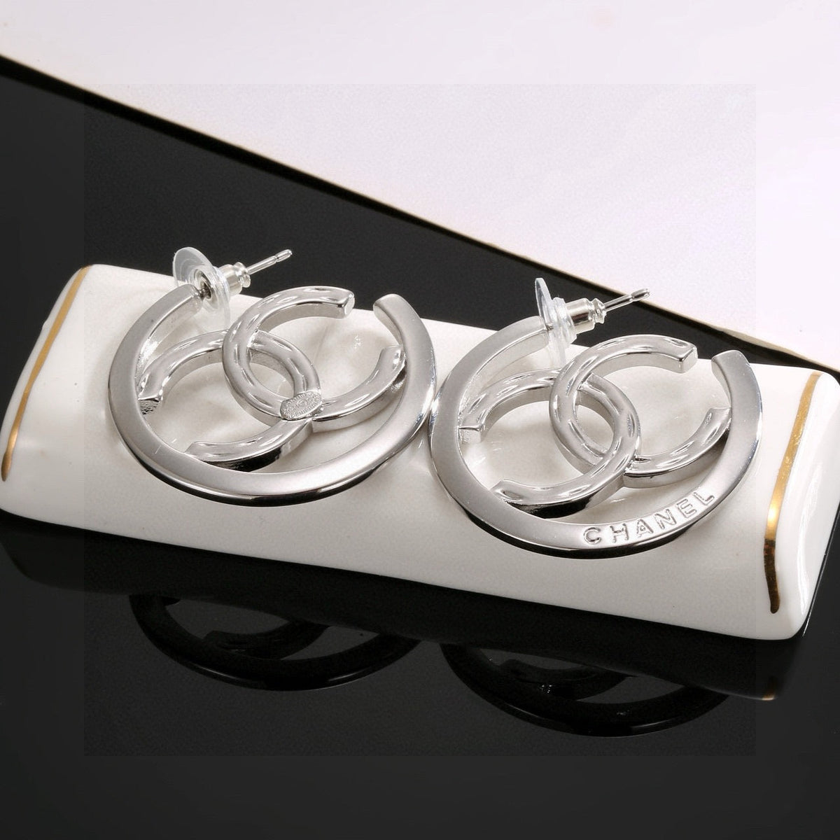 Martin Graham stud earrings in polished metal-tone – front product view