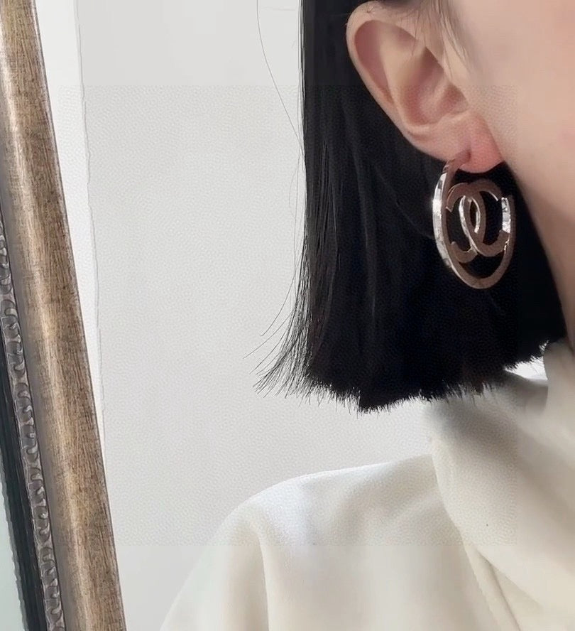 Martin Graham stud earrings in polished metal-tone – detail view