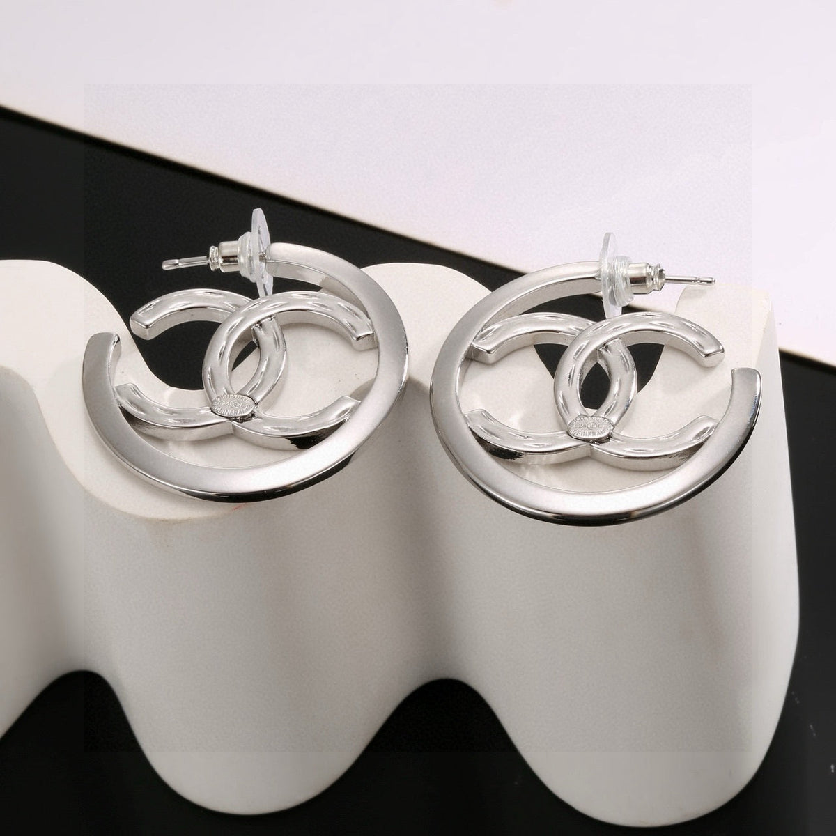 Martin Graham stud earrings in polished metal-tone – styled product view