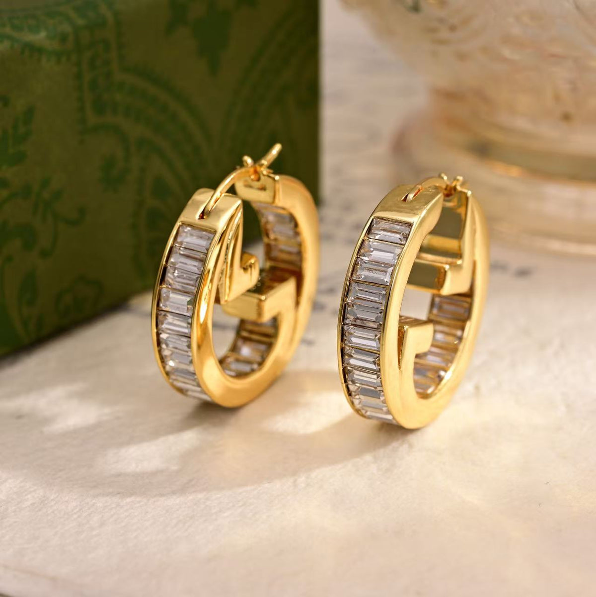 Martin Graham stud earrings in polished metal-tone – front product view