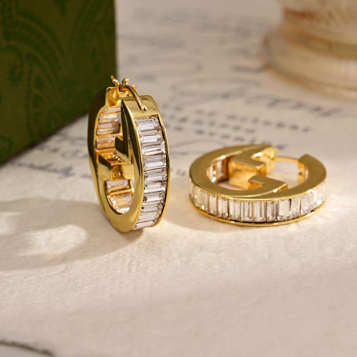 Martin Graham stud earrings in polished metal-tone – styled product view