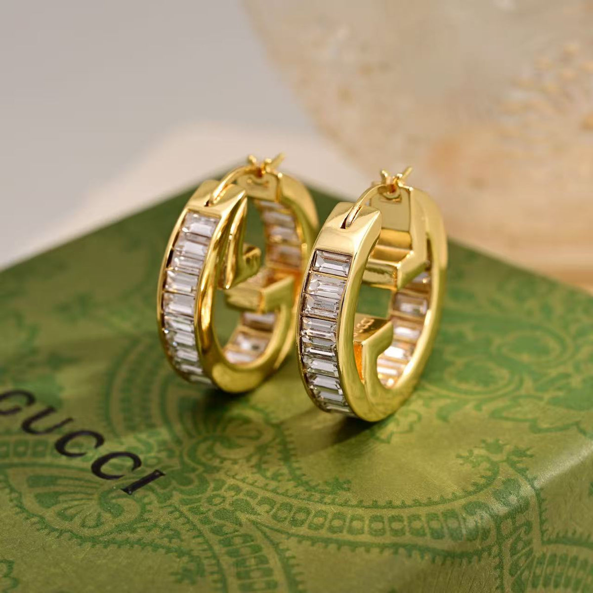 Martin Graham stud earrings in polished metal-tone – detail view