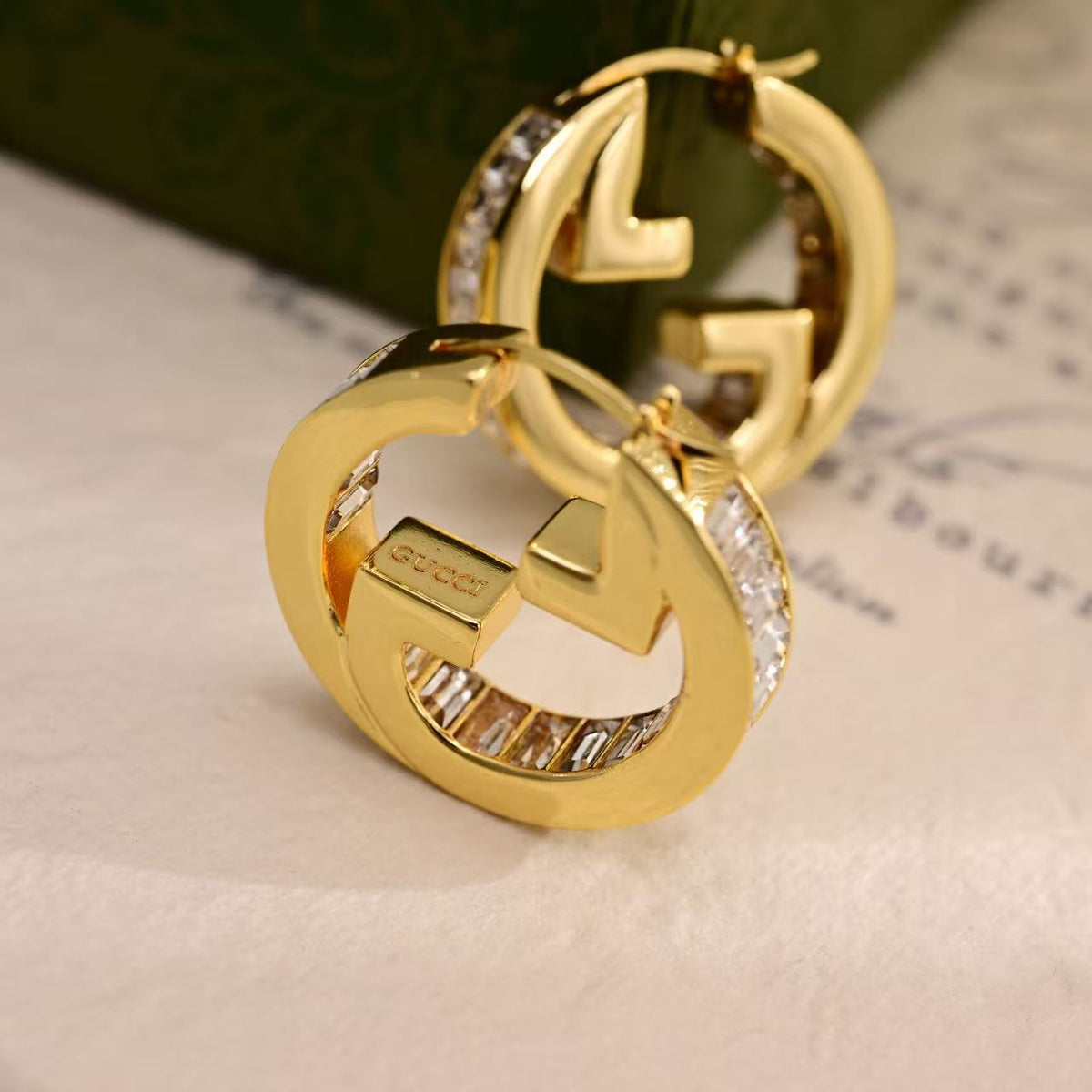 Martin Graham stud earrings in polished metal-tone – close-up detail