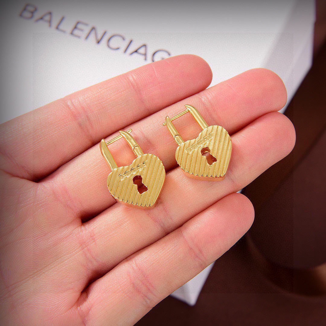 Martin Graham earrings in polished metal-tone – close-up detail