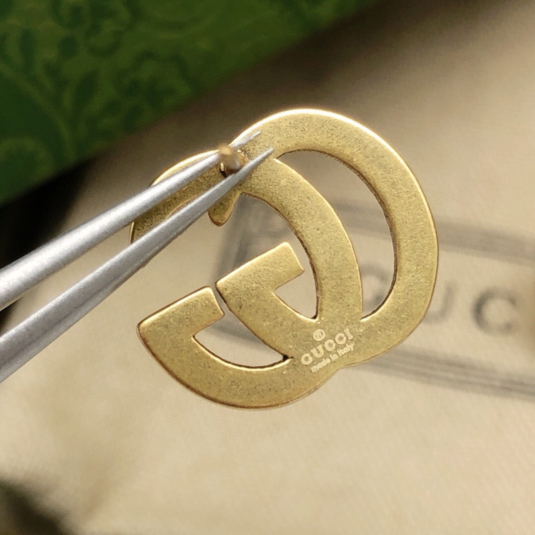 Martin Graham stud earrings in polished metal-tone – styled product view