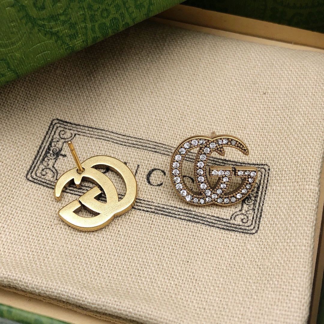 Martin Graham stud earrings in polished metal-tone – close-up detail