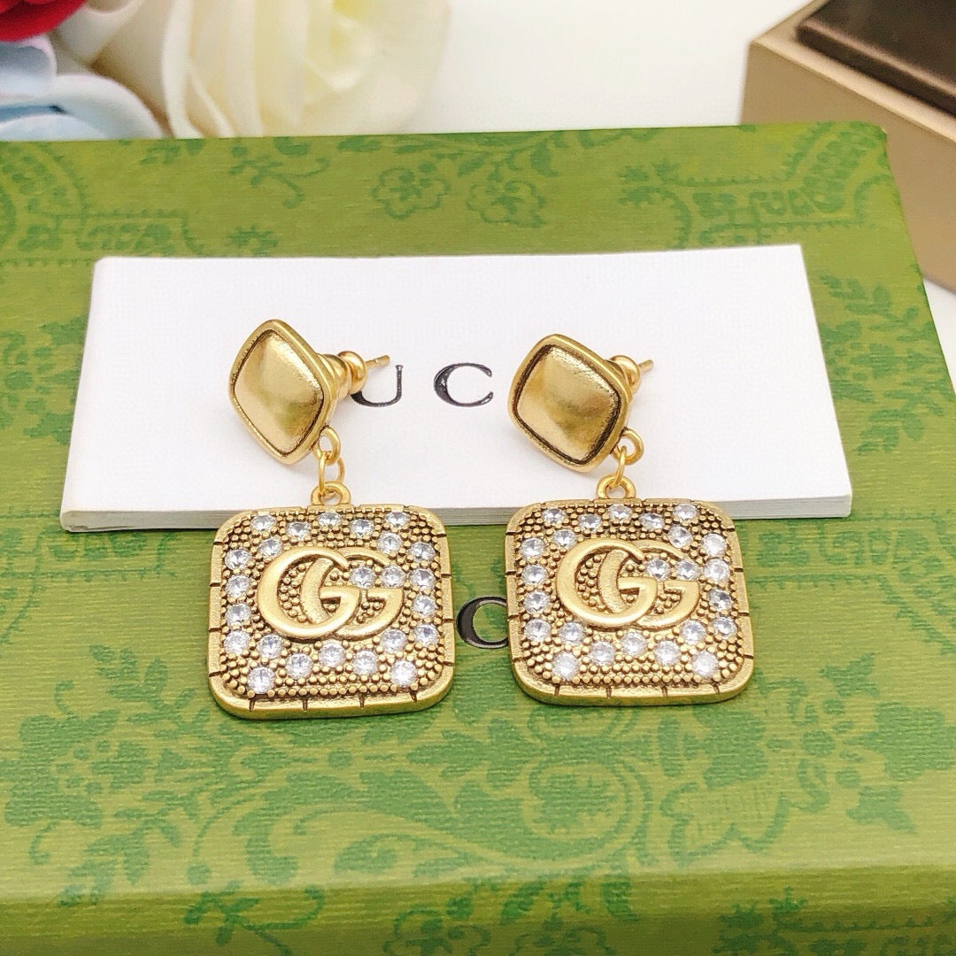 Martin Graham stud earrings in polished metal-tone – styled product view