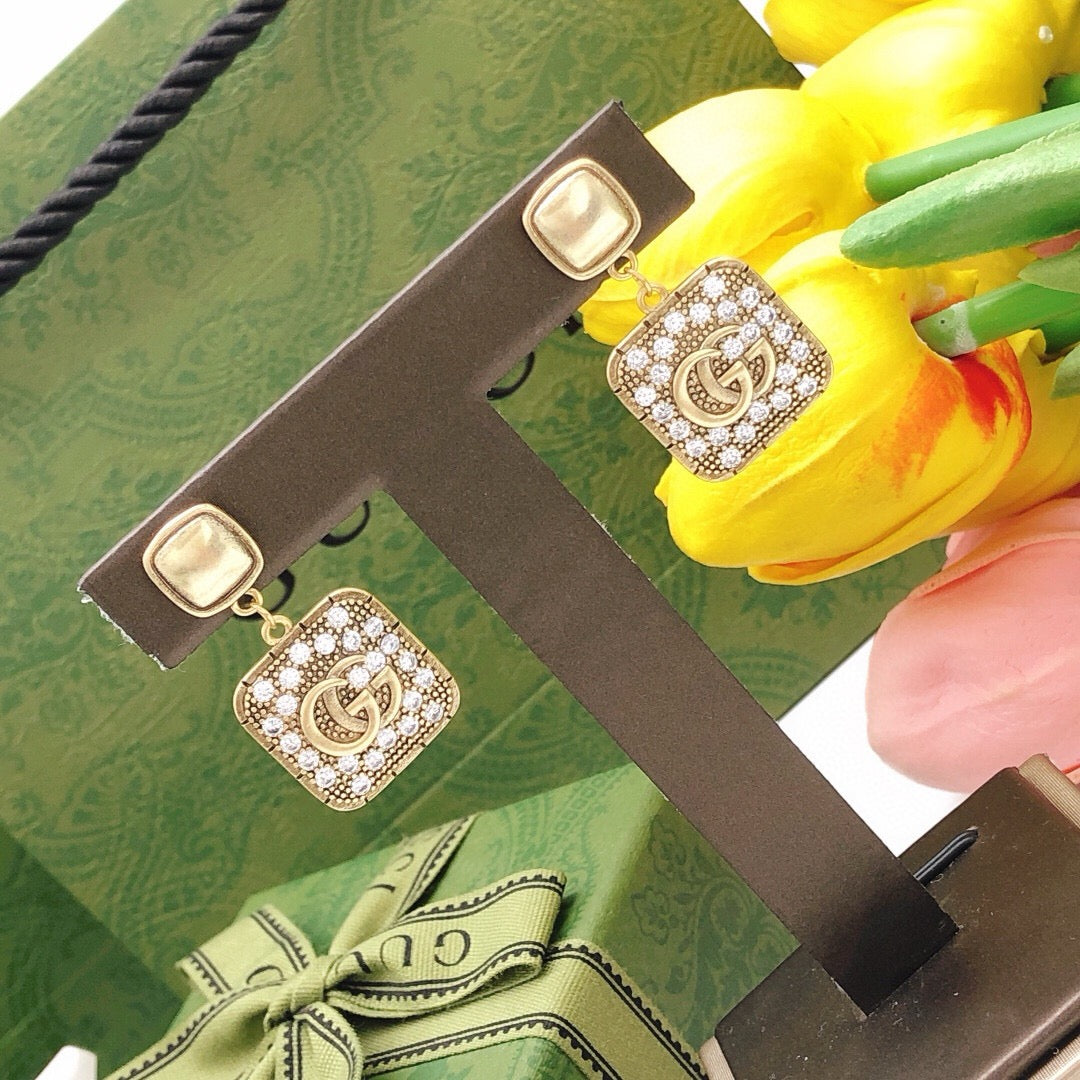 Martin Graham stud earrings in polished metal-tone – close-up detail