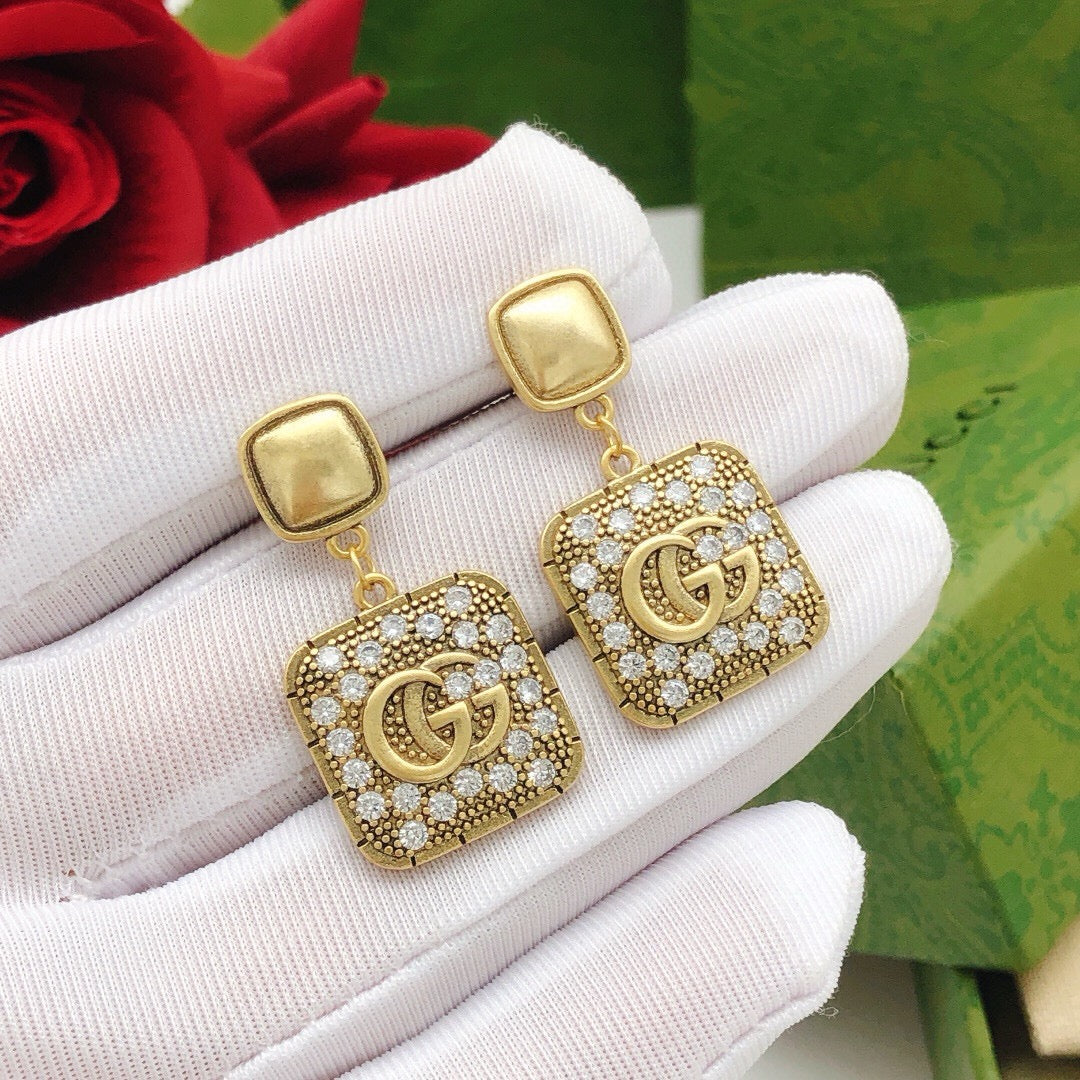 Martin Graham stud earrings in polished metal-tone – side detail